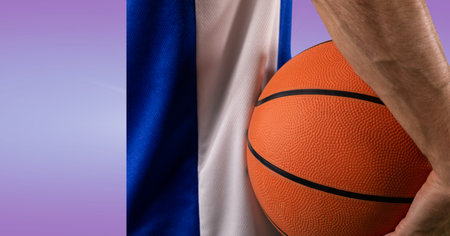 Composition of male basketball player holding basketball with copy space. sport and competition concept digitally generated image.の写真素材