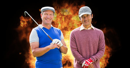Portrait of diverse senior male golf player smiling against fire flame effect on black background. retirement sports and active senior lifestyle conceptの写真素材