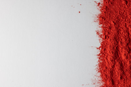 Close up of red powder with copy space on white background. Holi festival, colour, hindu tradition and celebration concept.の写真素材