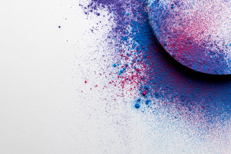 Close up of multi coloured powder with white circle and copy space on white background. Holi festival, colour, hindu tradition and celebration concept.の写真素材