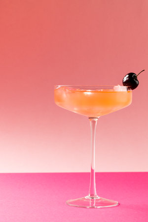 Vertical image of glass with drink and fruits over pink background. Drinks, cocktails, beverages and party concept.の写真素材