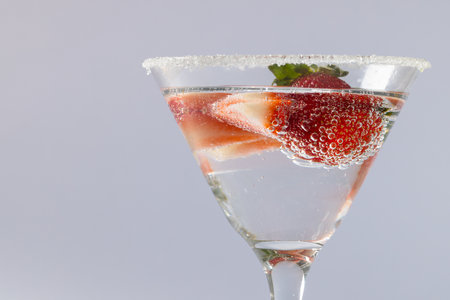 Glass with drink and fruits over grey background. Drinks, cocktails, alcohol, beverages and party concept.の写真素材