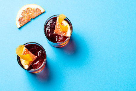 Glasses with cocktails with fruits over blue surface. Drinks, cocktails, alcohol, beverages and party concept.の写真素材