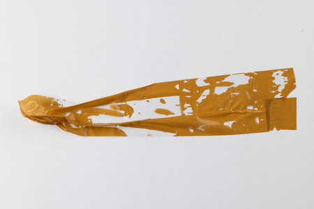 Ripped up pieces of orange tape with copy space on white background. Abstract paper texture...