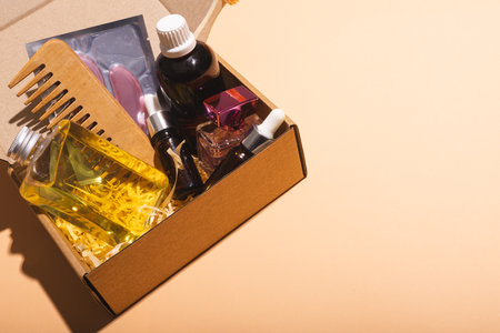 Box with beauty products and copy space over cream background. Cyber monday, black friday, online shopping, shipping and global connections concept.の写真素材