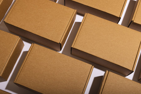 Rows of cardboard gift boxes with copy space over white background. Cyber monday, black friday, online shopping, shipping and global connections concept.の写真素材