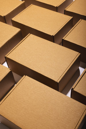 Vertical image of rows of cardboard gift boxes with copy space over white background. Cyber monday, black friday, online shopping, shipping and global connections concept.の写真素材