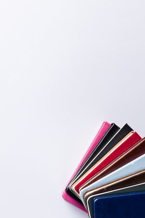 Close up of stack of books and notebooks with copy space on white background. Reading, learning,...
