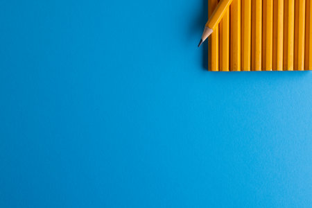 Close up of yellow pencils and copy space on blue background. Writing, drawing, learning, school and education concept.の写真素材
