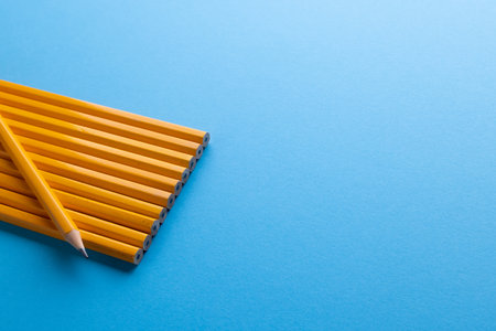 Close up of yellow pencils and copy space on blue background. Writing, drawing, learning, school and education concept.の写真素材