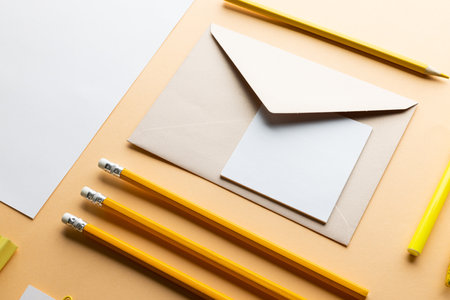 Flat lay of yellow pencils, pen and white paper with copy space on yellow background. School materials, writing, colouring, drawing, learning, school and education concept.の写真素材