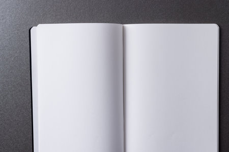 Close up of open book with copy space on green background. Literature, reading, writing, leisure...