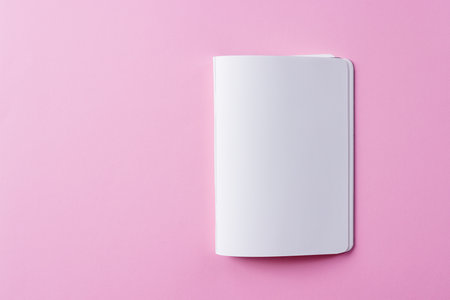 Close up of open book with copy space on pink background. Literature, reading, writing, leisure time and books.の写真素材