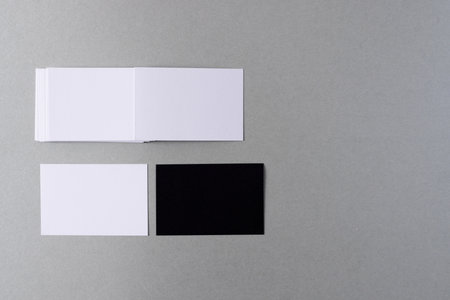 White and black business cards with copy space on grey background. Business, business card, stationery and writing space digitally generated image.の写真素材