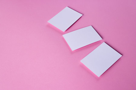 White business cards with copy space on pink background. Business, business card, stationery and...