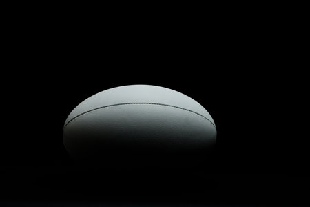 White rugby ball with copy space on black background. Rugby, sport, international, competition and games digitally generated image.の写真素材