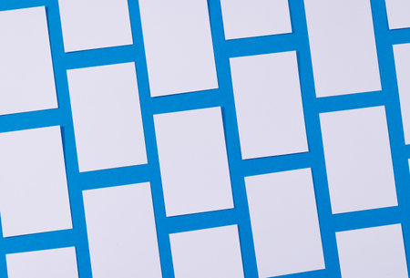 White business cards with copy space on blue background. Business, business card, stationery and writing space concept.の写真素材