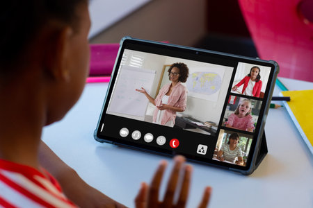 African american boy attending online class over digital tablet with teacher and students on screen....