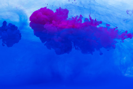 Close up of blue and pink ink in water with copy space background. Ink, liquid, shape and colour concept.の写真素材