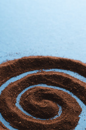 Close up of pattern of brown sand and copy space on blue background. Sand, texture, movement, shape and colour concept.の写真素材