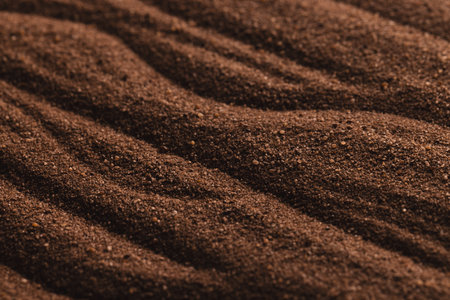 Close up of pattern of brown sand and copy space background. Sand, texture, movement, shape and colour concept.の写真素材