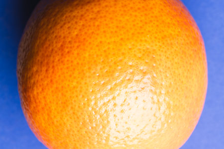 Close up of orange and copy space on blue background. Fruit, exotic fruit, food, freshness and...