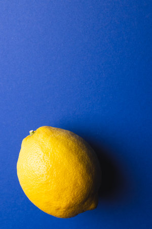 Close up of lemon and copy space on blue background. Fruit, exotic fruit, food, freshness and colour concept.の写真素材