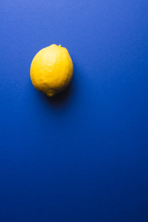 Close up of lemon and copy space on blue background. Fruit, exotic fruit, food, freshness and colour...