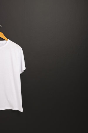White t shirt on hanger and copy space on black background. Fashion, clothes, colour and fabric concept.の写真素材