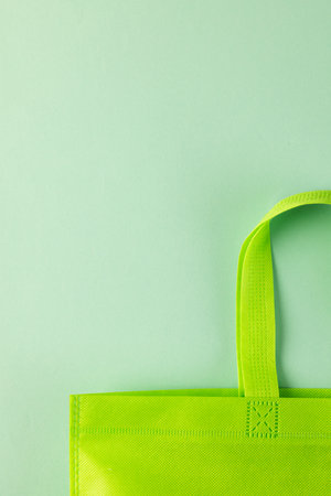 Close up of green canvas bag with copy space on green background. Shopping, bag, colour, fabric, texture and materials concept.の写真素材