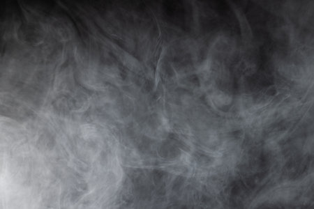 White clouds of smoke with copy space on black background. Halloween, colour, movement and smoke concept.の写真素材