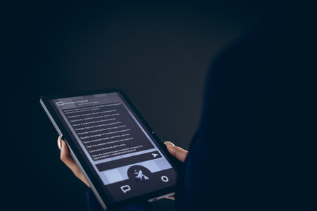 Biracial businesswoman using tablet with copy space on black background. Technology, digital...