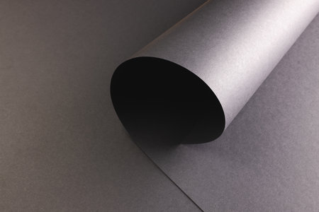 Close up of layers of pieces of black paper with copy space on black background. Paper, writing, texture and materials concept.の写真素材