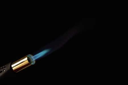 Close up of lit torch light with copy space on black background. Fire, flames, heat and light concept.の写真素材