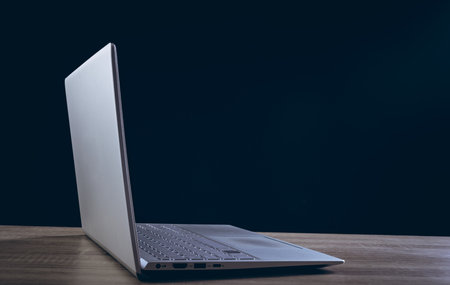 Open laptop with copy space on black background. Technology, digital networks, global connections and communication metaverse.の写真素材