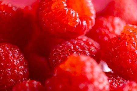 Micro close up of raspberries with copy space. Micro photography, fruit, food, texture and colour concept.の写真素材
