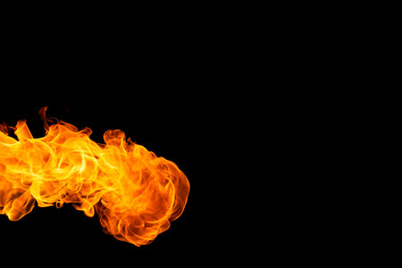 Close up of yellow and orange flames and copy space on black background. Fire, flames, heat and...