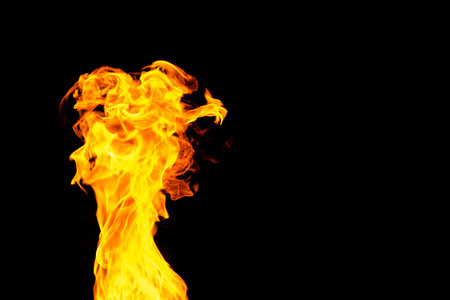 Close up of yellow flames and copy space on black background. Fire, flames, heat and light concept.の写真素材