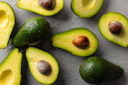 Micro close up of avocados with water drops and copy space on grey background. Micro photography,...