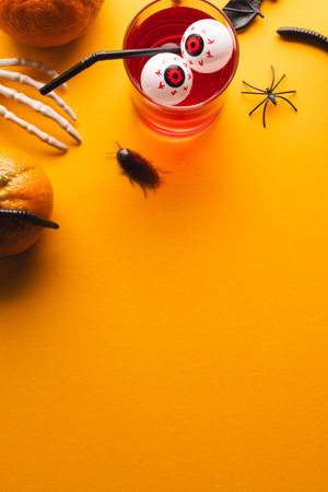 Vertical image of halloween decorations and food with copy space on yellow background. Fall, autumn, halloween, tradition and celebration concept.の写真素材