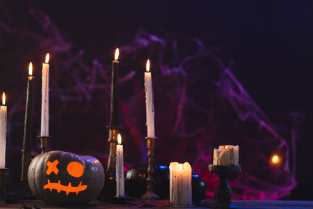 Pumpkins and candles with copy space on purple background. Fall, autumn, halloween, tradition and celebration concept.の写真素材