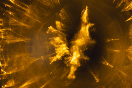 Yellow bokeh blurred lights with copy space on dark background. Light, colour and shape concept digitally generated image.の写真素材