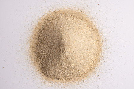 Close up of heap of sand and copy space on white background. Sand, texture, shape and colour concept.の写真素材