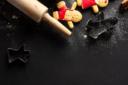 Christmas cookies cutters, roller with copy space on black background. Sweets, christmas, tradition and celebration concept.の写真素材