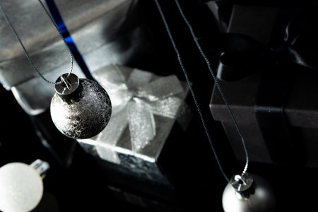 Silver christmas baubles and gifts with copy space on black background. Christmas, decorations, tradition and celebration concept.の写真素材