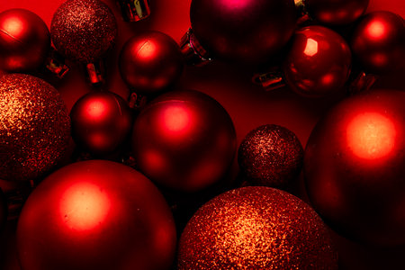 Christmas red baubles decorations with copy space on red background. Christmas, decorations,...