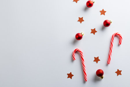 Christmas red baubles, stars and candy canes with copy space on white background. Christmas, decorations, tradition and celebration concept.の写真素材
