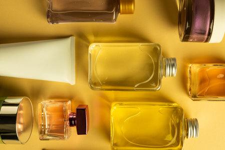 Flat lay of beauty products bottles, tub and tube with copy space on yellow background. Health and beauty, beauty product, make up and colour concept.の写真素材