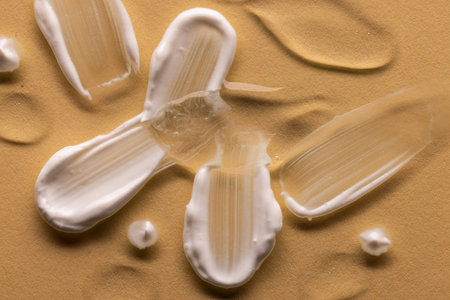 Close up of beauty product white cream and clear serum smudge with copy space on brown background. Health and beauty, beauty product, make up and colour concept.の写真素材