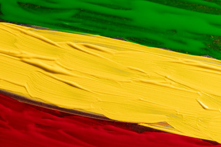 Green, yellow and red paints with copy space background. Black history month, africa, black culture and history concept.の写真素材